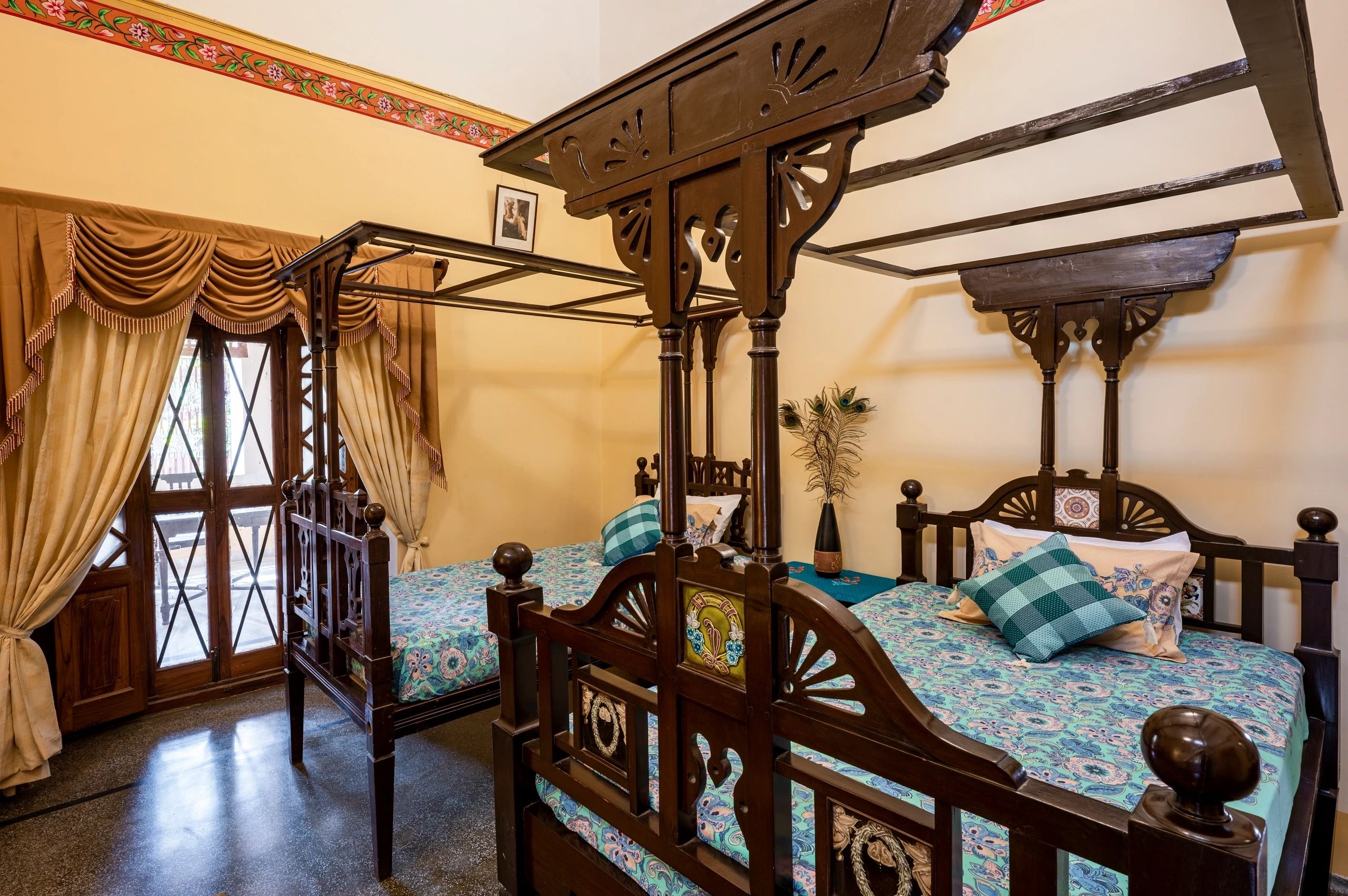 Luxurious canopy four poster bed with turquoise bedding