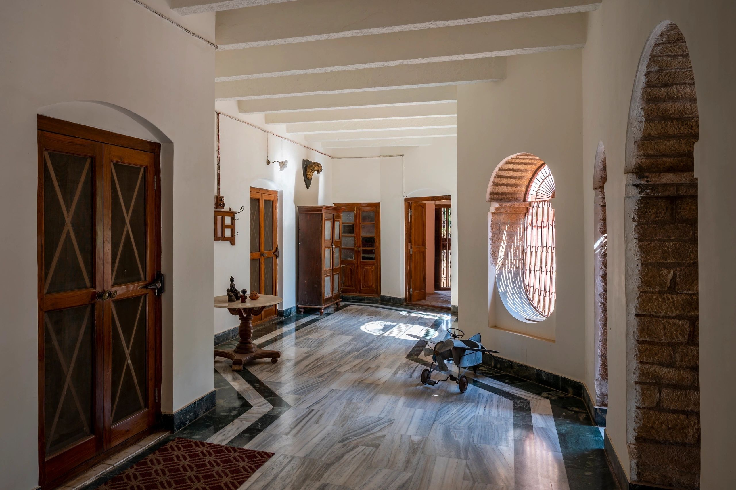 Colonial interior hallway with wooden floors and beams