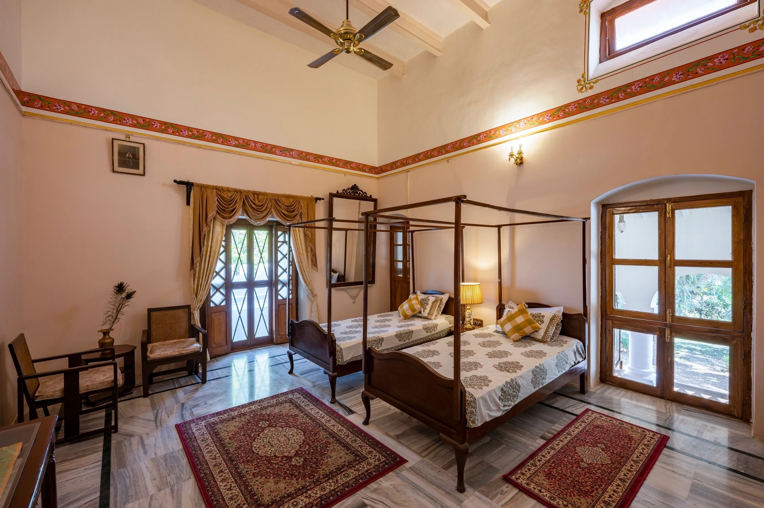 Royal bedroom with four poster beds in Indian heritage palace